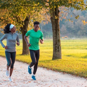 Running Couple running in a fall colored park